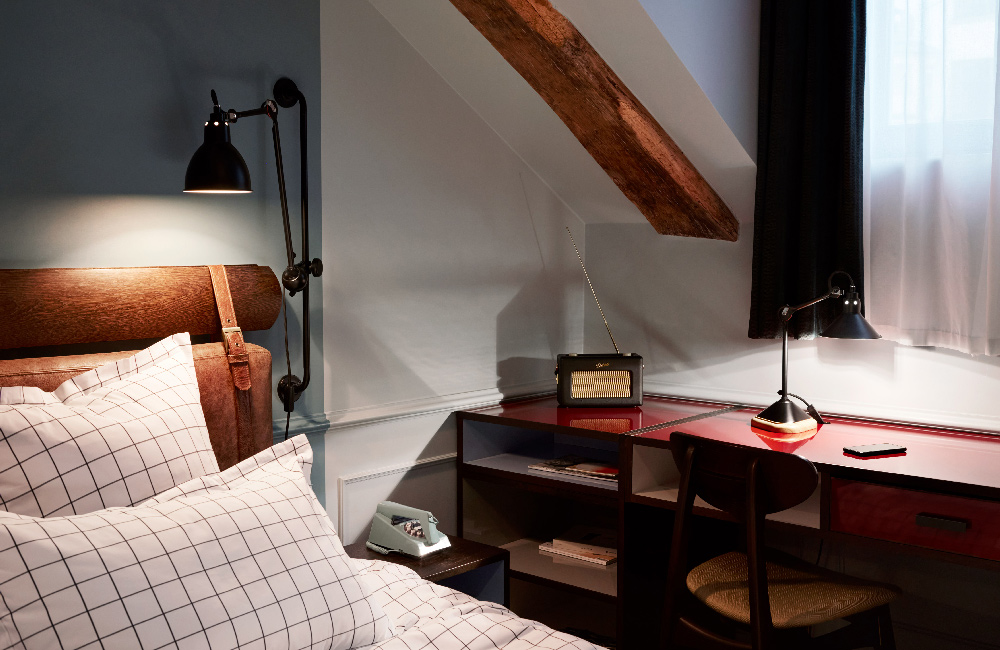 Side of the bed with desk and reading light