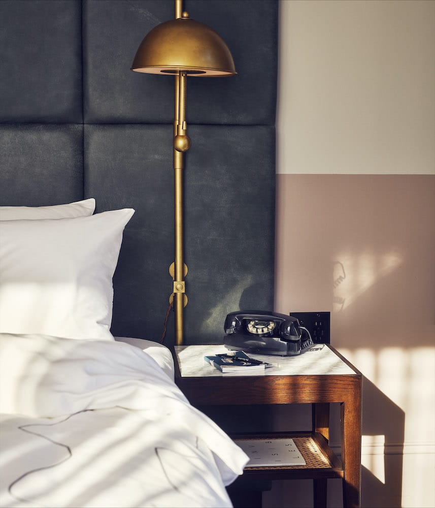 Bedside table with old-fashioned telephone and lamp
