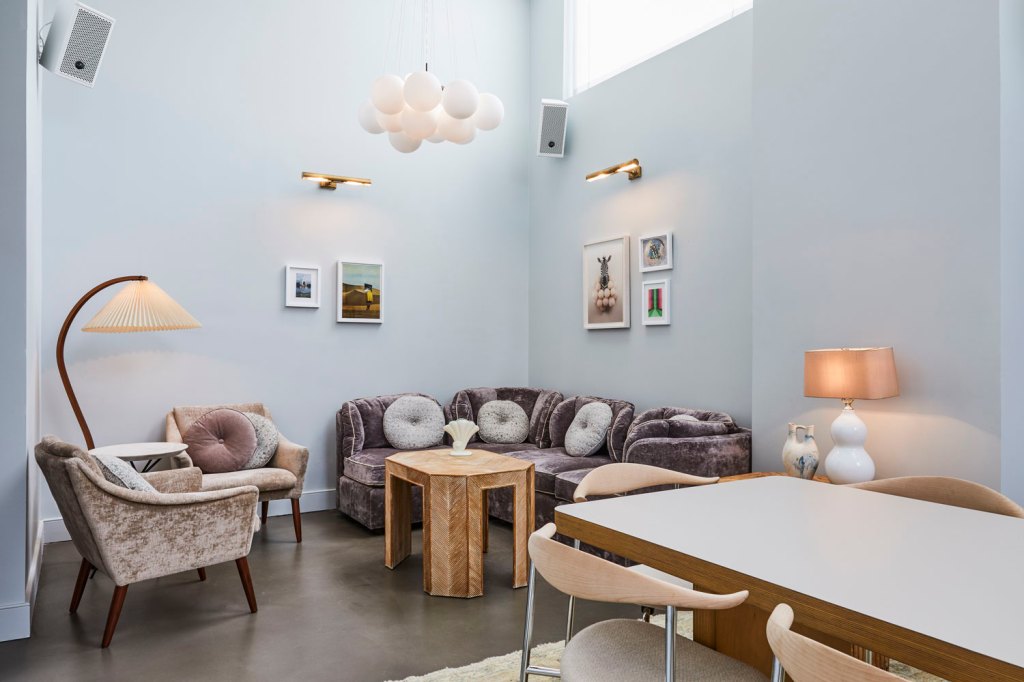 This room has a comfortable seating area at one end of the room, with a long table with chairs at the other