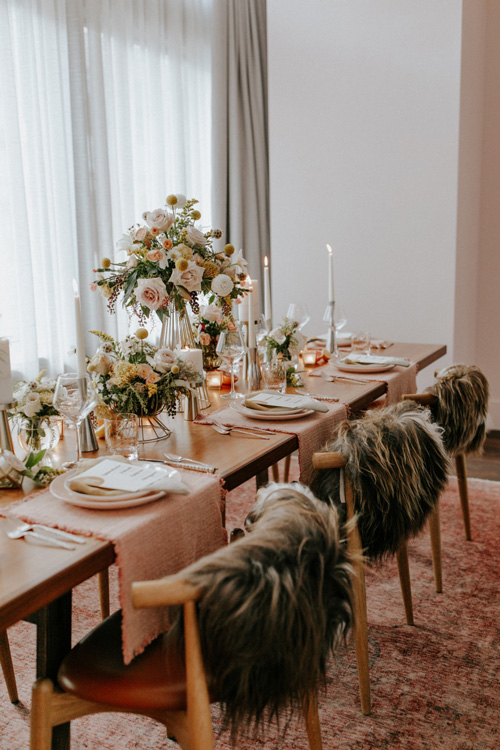 Beautiful table setting laid out for a wedding with a range flowers and candles