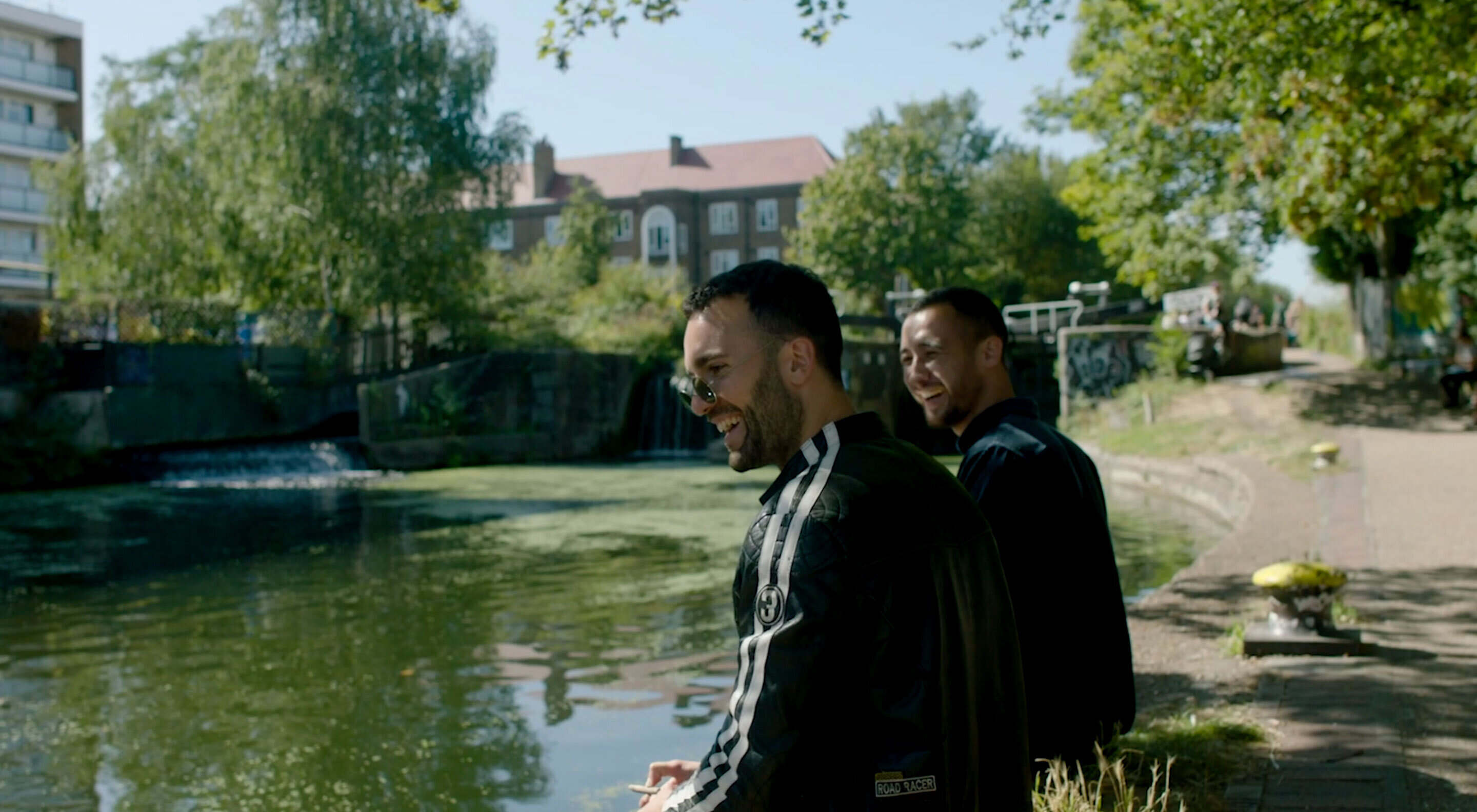 Two guys hanging out by the canal
