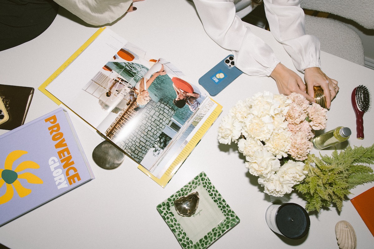 Foto di Nic Ford. Tavolo che espone diversi articoli da regalo, come ad esempio i libri da salotto - The Localist, Hoxton Hotels.